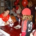 Kelli__barnhart_signing_ball__hanah_waiting_thumb